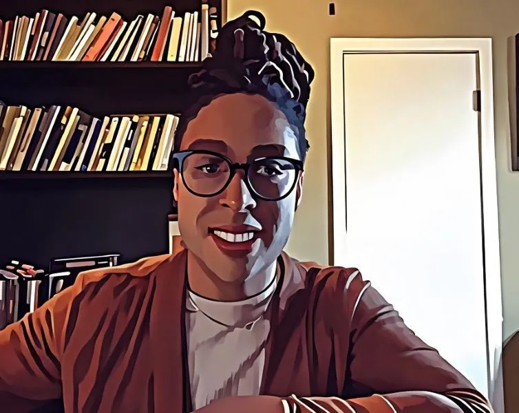 Safia, The Investor Professor, smiling in front of a bookshelf and ready to guide clients through the four-week wealth activation journey.